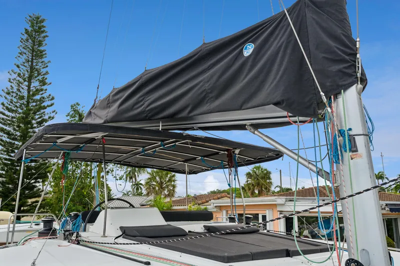 Cruisin Cajun Yacht Photos Pics 2017 Lagoon 450 F catamaran with covered deck, ropes, and lush background.