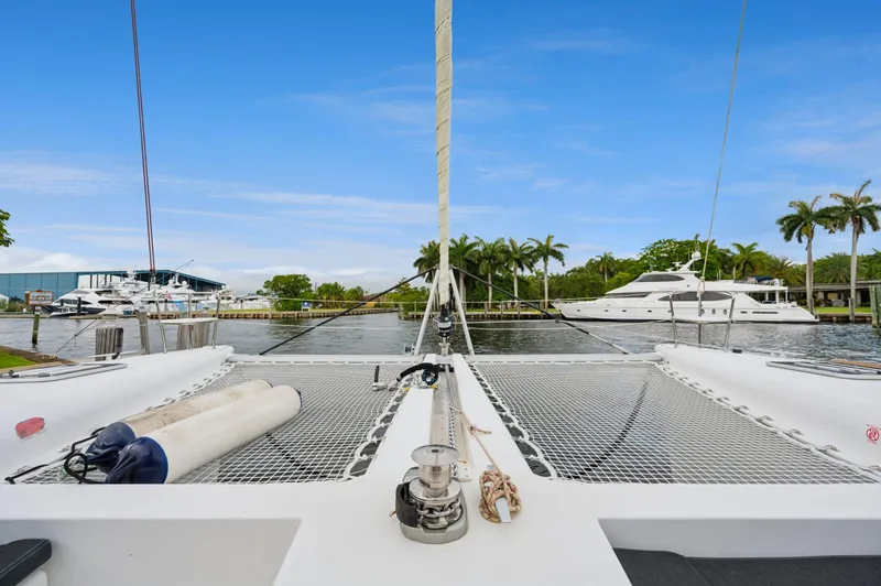 Cruisin Cajun Yacht Photos Pics Front deck of 2017 Lagoon 450 F catamaran docked by palm trees and yachts.