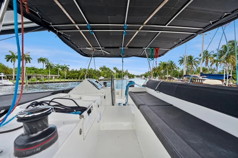 Cruisin Cajun Yacht Photos Pics 2017 Lagoon 450 F catamaran cockpit with seating, docked in a tropical marina.