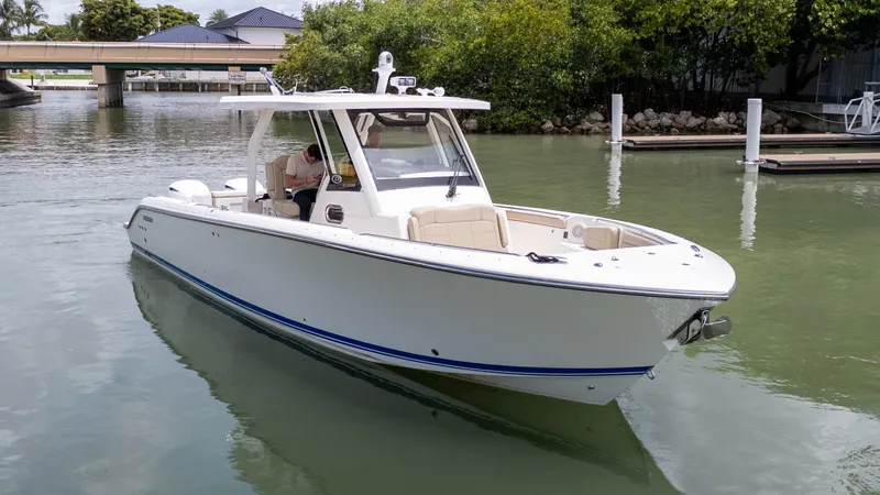 Burnin' Daylight Yacht Photos Pics 2018 Pursuit S 328 boat cruising in a calm marina setting.