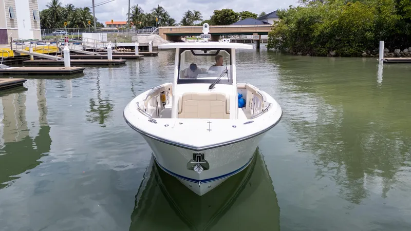 Burnin' Daylight Yacht Photos Pics 2018 Pursuit S 328 boat docked in a calm marina setting.