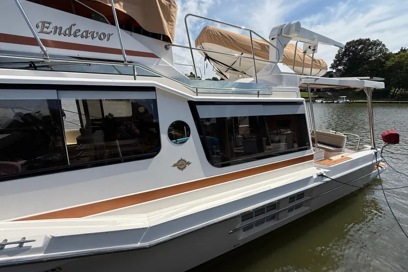  Yacht Photos Pics 2021 Ranger Tugs R-41CB boat docked on a calm lake.