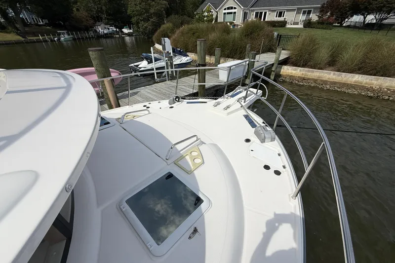  Yacht Photos Pics 2021 Ranger Tugs R-41CB yacht docked at a serene waterfront location.