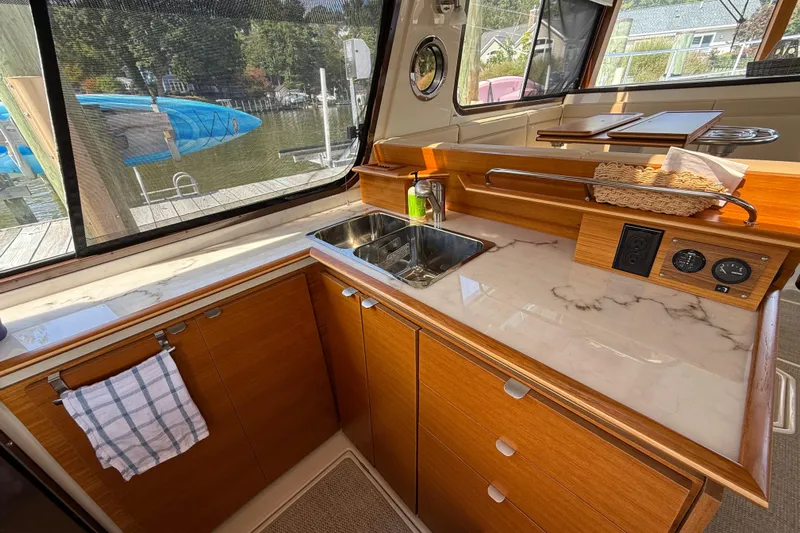  Yacht Photos Pics 2021 Ranger Tugs R-41CB boat interior with modern kitchen and marble countertop.