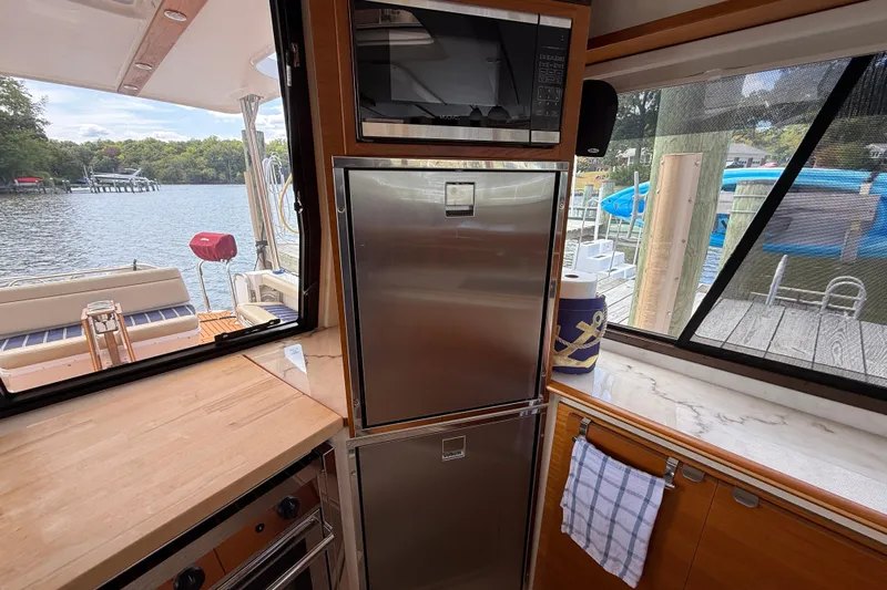  Yacht Photos Pics Interior of 2021 Ranger Tugs R-41CB yacht with kitchen appliances and scenic water view.