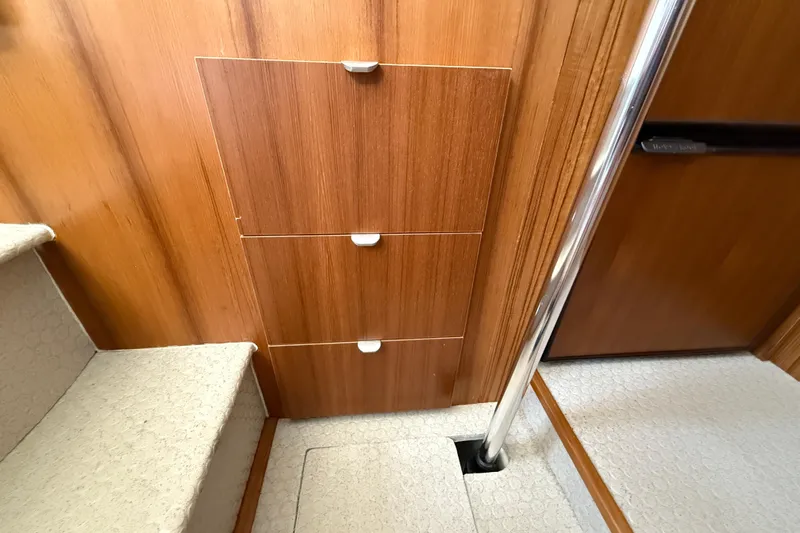  Yacht Photos Pics Interior of 2021 Ranger Tugs R-41CB with wooden cabinetry and carpeted stairs.