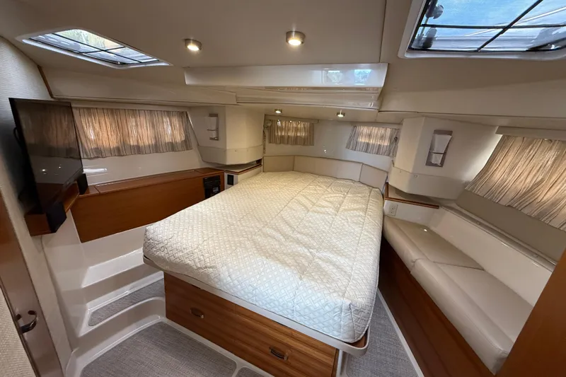  Yacht Photos Pics Luxurious 2021 Ranger Tugs R-41CB cabin interior with bed, TV, and seating.