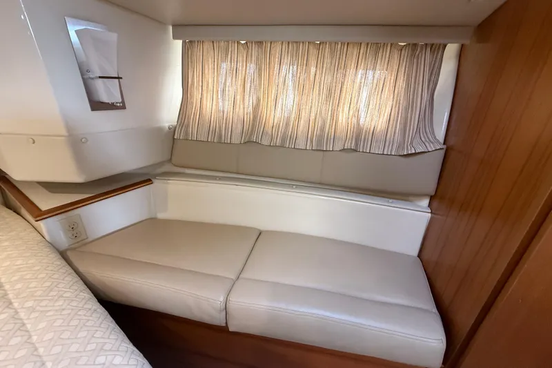  Yacht Photos Pics 2021 Ranger Tugs R-41CB interior cabin with cushioned seating and striped curtains.