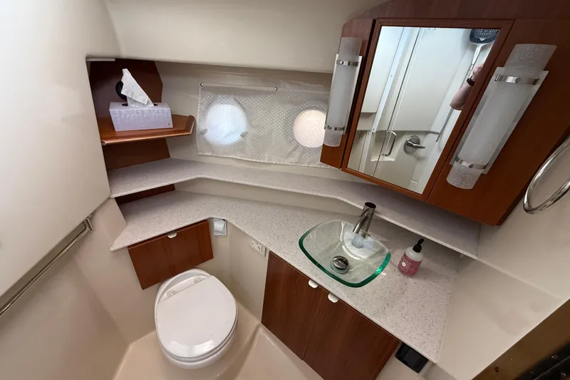  Yacht Photos Pics 2021 Ranger Tugs R-41CB bathroom with modern fixtures and wooden cabinetry.