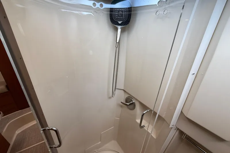  Yacht Photos Pics Shower area in 2021 Ranger Tugs R-41CB boat, featuring modern fixtures and glass door.