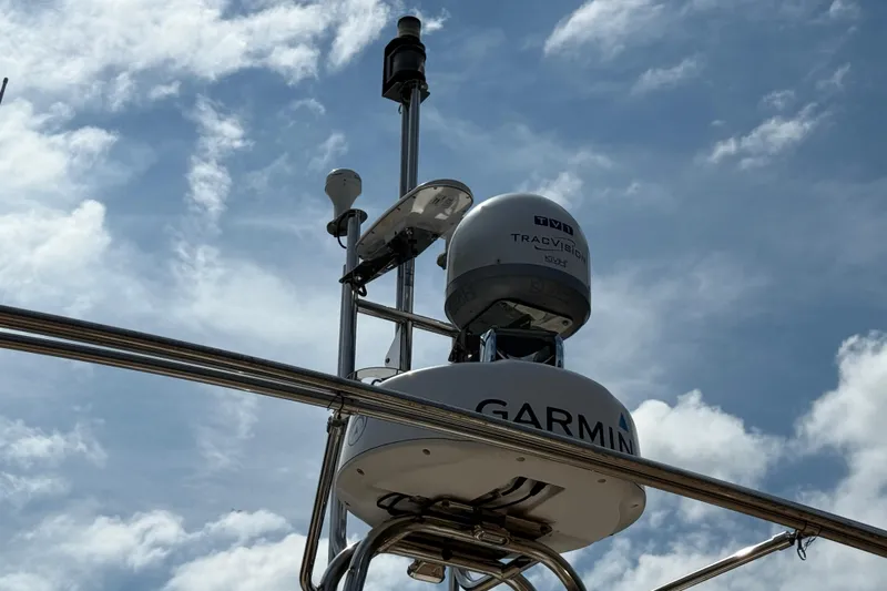  Yacht Photos Pics Radar and communication equipment on 2021 Ranger Tugs R-41CB against a cloudy sky.