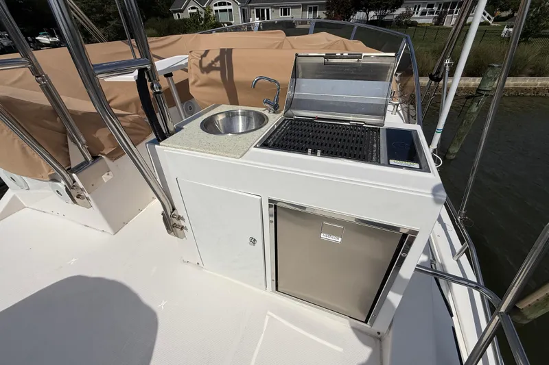  Yacht Photos Pics Outdoor kitchen on 2021 Ranger Tugs R-41CB boat with sink, grill, and fridge.