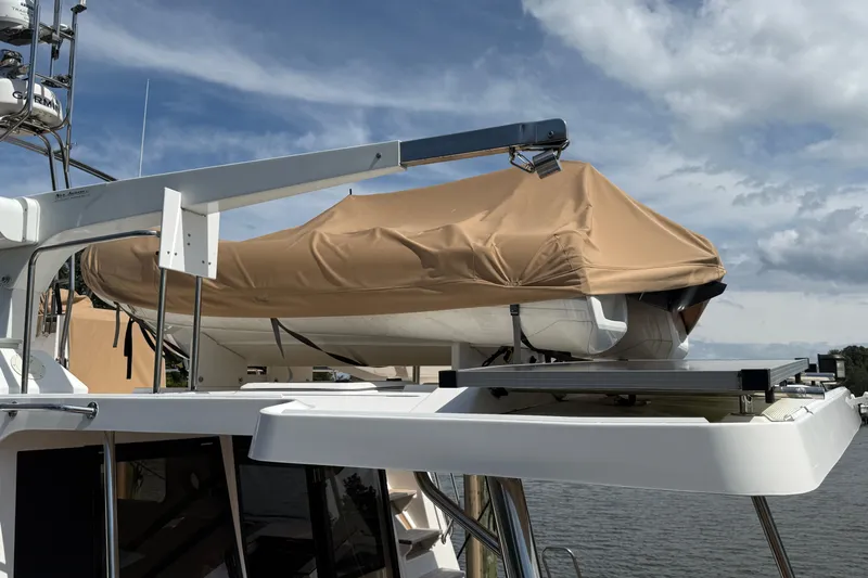  Yacht Photos Pics 2021 Ranger Tugs R-41CB with covered dinghy on deck under cloudy sky.