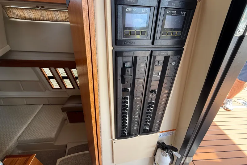  Yacht Photos Pics Electrical panel inside 2021 Ranger Tugs R-41CB boat, showing control switches and cabin interior.