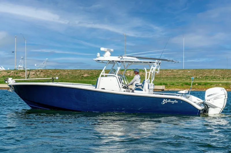  Yacht Photos Pics 2021 Yellowfin 32 Offshore boat on water, featuring sleek design and powerful engine.