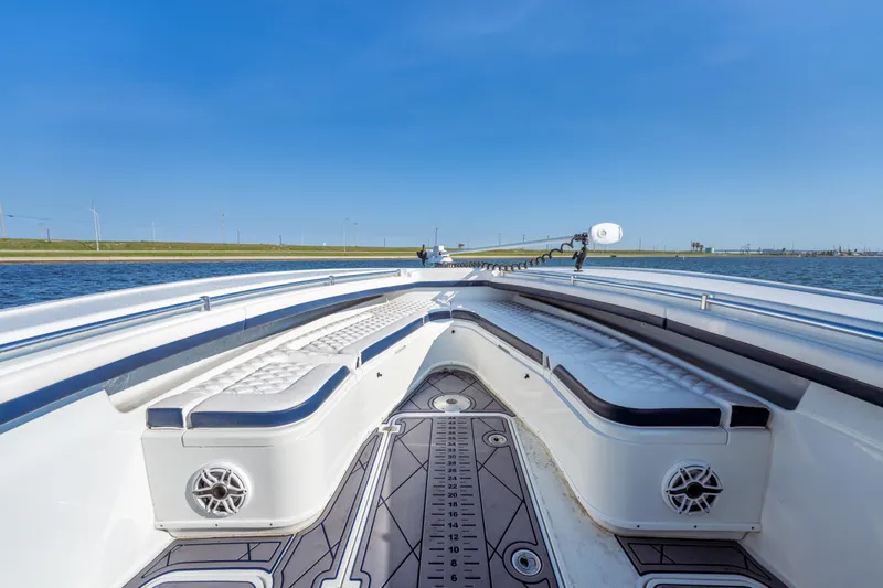  Yacht Photos Pics 2021 Yellowfin 32 Offshore boat interior with cushioned seating and sleek design on open water.