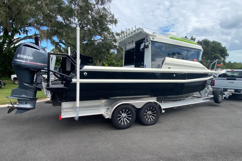  Yacht Photos Pics 2024 Sea King 260 boat on trailer with Yamaha outboard motor, parked outdoors.