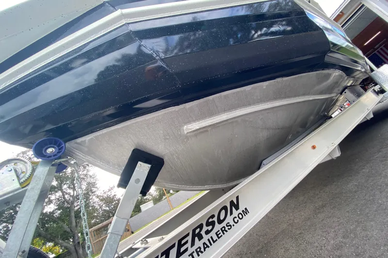  Yacht Photos Pics 2024 Sea King 260 boat on trailer, showcasing hull design and trailer branding.