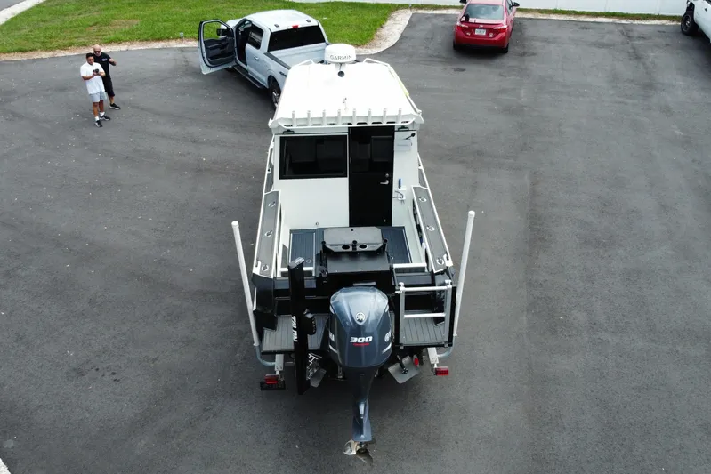  Yacht Photos Pics 2024 Sea King 260 boat with powerful outboard motor in parking lot.