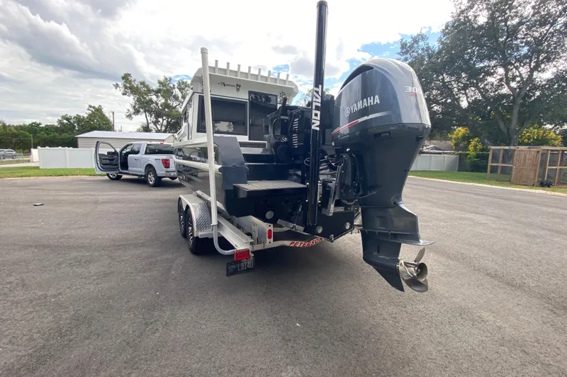  Yacht Photos Pics 2024 Sea King 260 boat with Yamaha motor on trailer, parked near a truck.