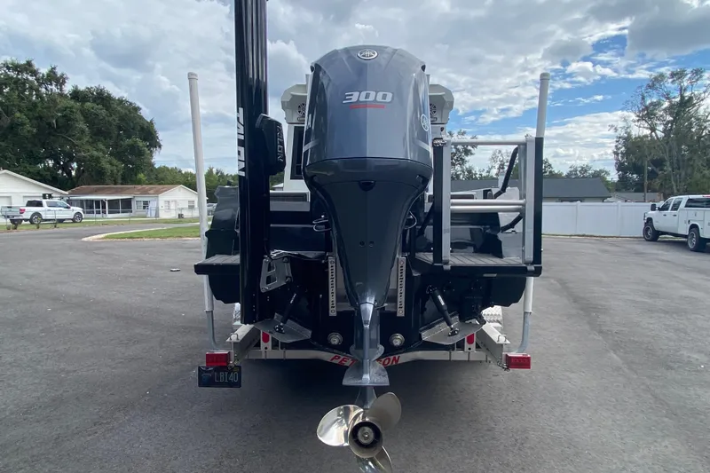 Yacht Photos Pics 2024 Sea King 260 boat with powerful 300 horsepower outboard motor, parked on a trailer.
