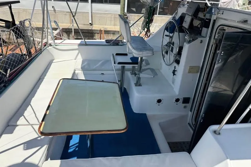  Yacht Photos Pics 1993 Jeanneau Lagoon 37 TPI Catamaran cockpit with seating, table, and steering wheel.