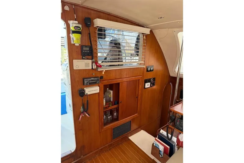  Yacht Photos Pics Interior of 1993 Jeanneau Lagoon 37 TPI Catamaran with wooden paneling and navigation equipment.