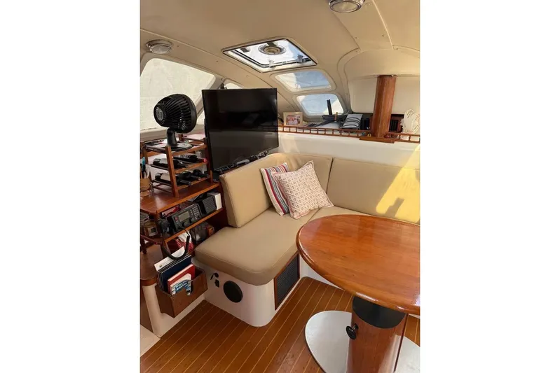  Yacht Photos Pics Interior of 1993 Jeanneau Lagoon 37 TPI Catamaran with cozy seating and wooden table.