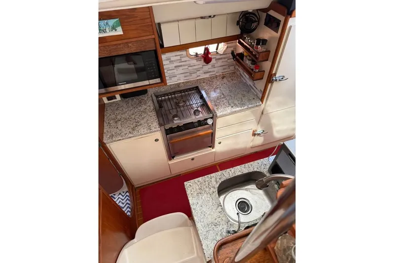  Yacht Photos Pics 1993 Jeanneau Lagoon 37 TPI Catamaran kitchen with granite countertops and modern appliances.