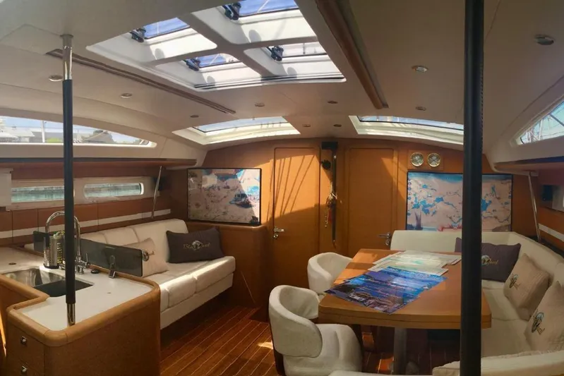 My Black Pearl Yacht Photos Pics Luxurious interior of a 2015 Jeanneau 57 yacht with elegant seating and skylights.