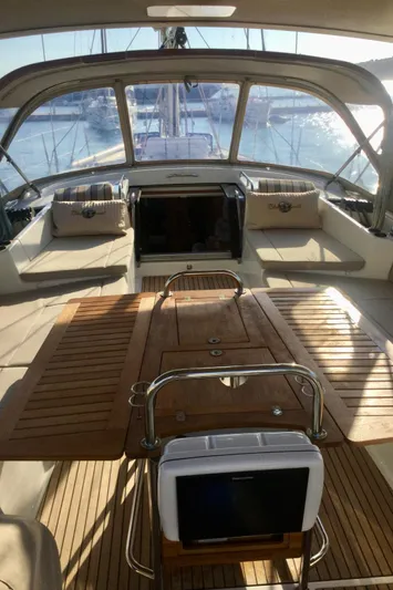 My Black Pearl Yacht Photos Pics Luxurious 2015 Jeanneau 57 yacht interior with spacious seating and elegant wooden table.