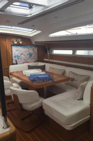 My Black Pearl Yacht Photos Pics Luxurious interior of 2015 Jeanneau 57 yacht with elegant seating and wooden accents.