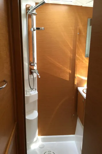 My Black Pearl Yacht Photos Pics 2015 Jeanneau 57 yacht bathroom with wooden paneling and modern shower.