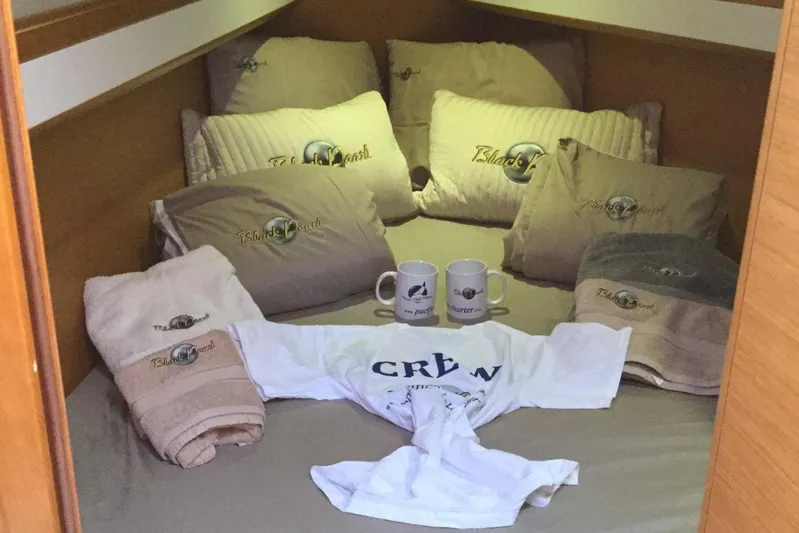 My Black Pearl Yacht Photos Pics Cozy cabin interior of 2015 Jeanneau 57 with branded pillows, mugs, and crew shirt.