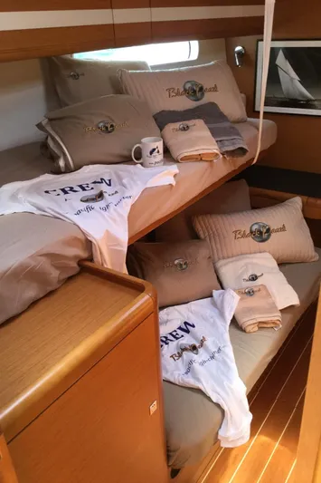 My Black Pearl Yacht Photos Pics Cozy cabin interior of 2015 Jeanneau 57 yacht with crew apparel and bedding.