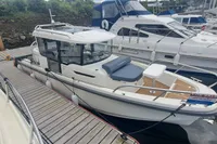 2023 Nimbus Commuter 8 boat docked, for sale, with sleek design and modern features.