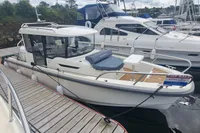 2023 Nimbus Commuter 8 boat docked, for sale sign visible, sleek design, marina setting.