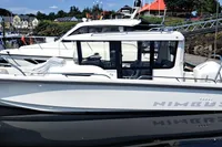 2023 Nimbus Commuter 8 boat docked at a marina, reflecting on calm water.