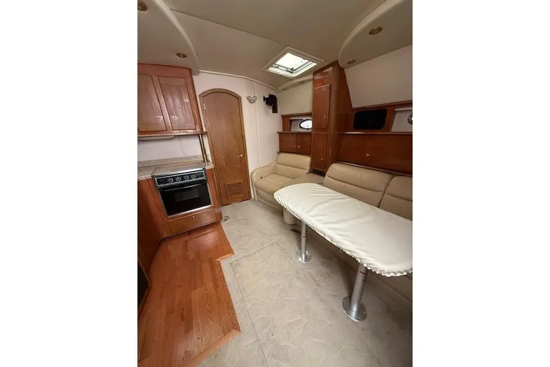  Yacht Photos Pics 2006 Rinker Fiesta Vee 410 interior with kitchen, seating, and table.