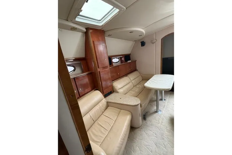  Yacht Photos Pics Luxurious interior of 2006 Rinker Fiesta Vee 410 yacht with leather seating and wooden cabinetry.