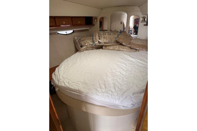  Yacht Photos Pics 2006 Rinker Fiesta Vee 410 cabin interior with bed and storage cabinets.