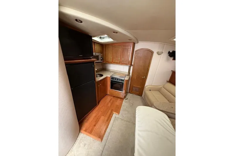  Yacht Photos Pics 2006 Rinker Fiesta Vee 410 interior with kitchen and seating area.