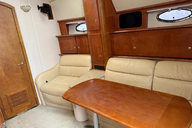 Yacht Photos Pics 2006 Rinker Fiesta Vee 410 interior with beige seating and wooden table.