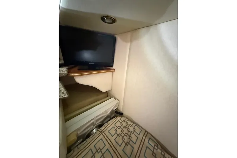  Yacht Photos Pics 2006 Rinker Fiesta Vee 410 cabin interior with TV and patterned upholstery.