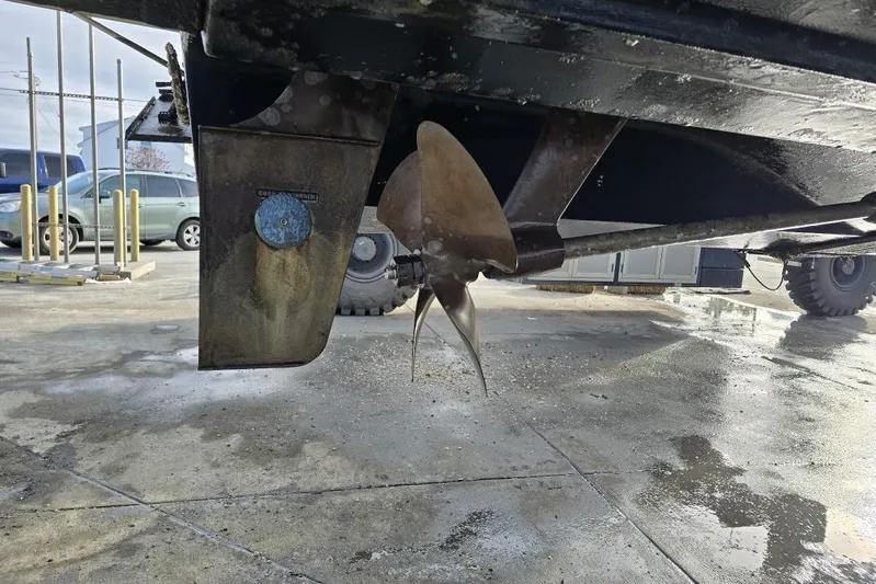  Yacht Photos Pics 2006 Rinker Fiesta Vee 410 boat propeller and rudder on a concrete surface.