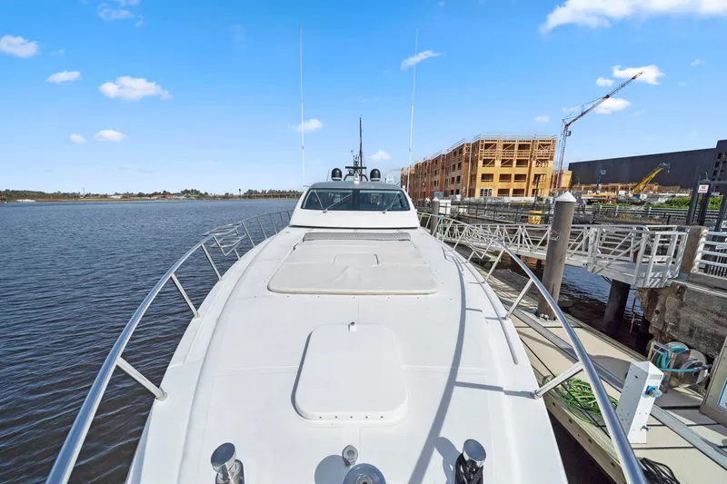 Double Down Yacht Photos Pics 2010 Mangusta 72 Express yacht docked by waterfront construction site.