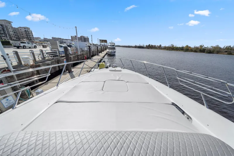 Double Down Yacht Photos Pics 2010 Mangusta 72 Express yacht docked at a marina with clear blue skies.