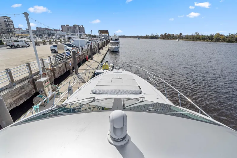 Double Down Yacht Photos Pics Bow view of 2010 Mangusta 72 Express yacht docked at a marina.