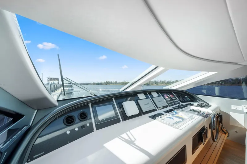 Double Down Yacht Photos Pics Interior view of 2010 Mangusta 72 Express yacht cockpit with modern navigation controls.