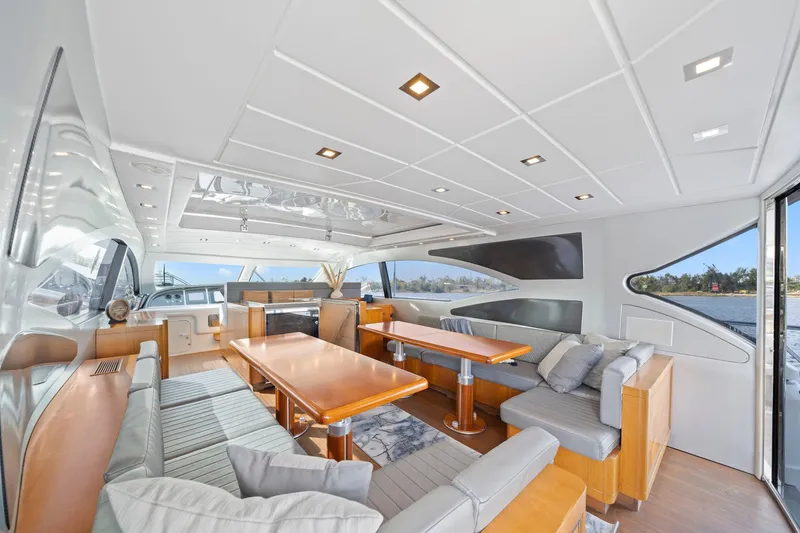 Double Down Yacht Photos Pics Luxurious interior of 2010 Mangusta 72 Express yacht with elegant seating and dining area.